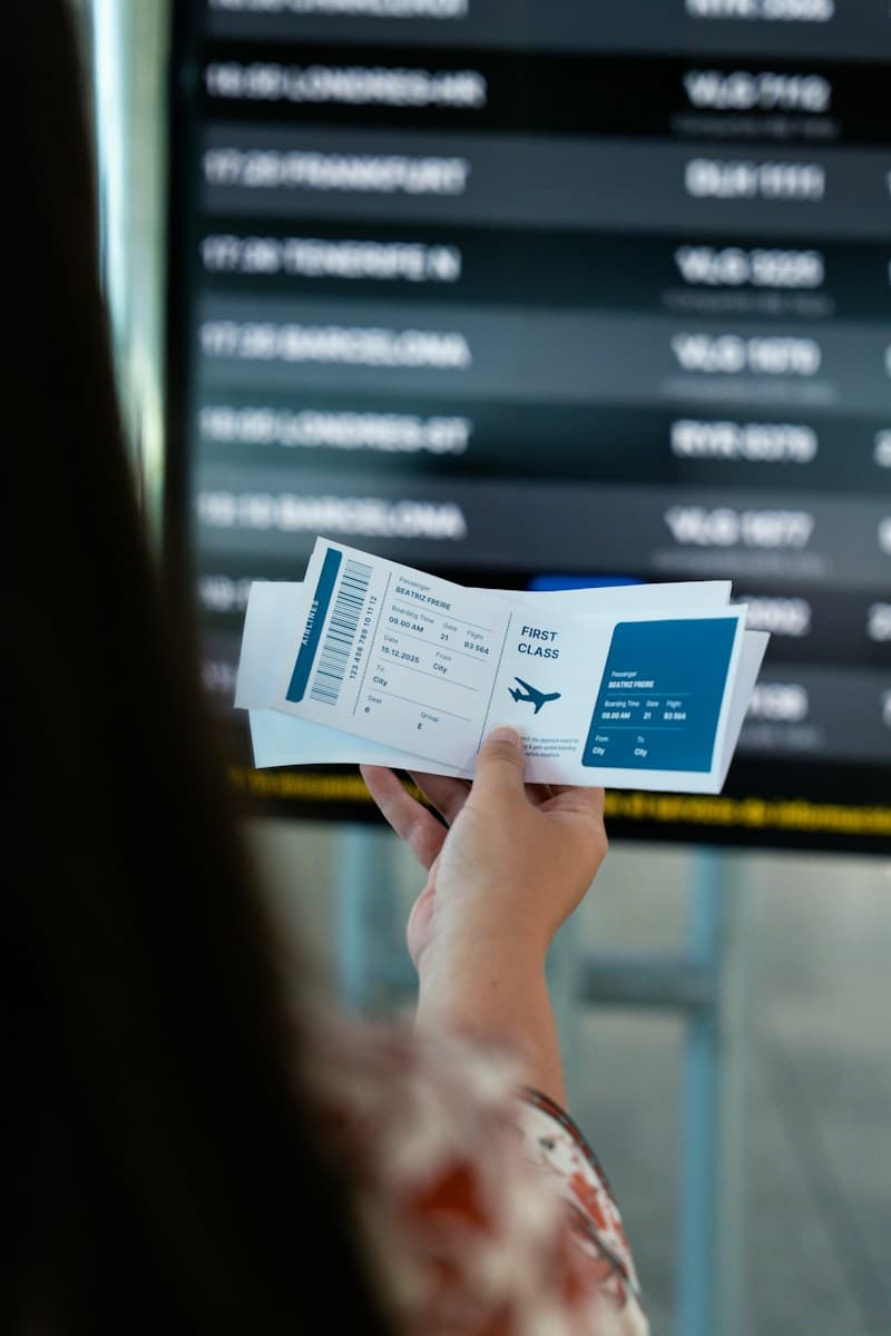 Happy traveler holding flight boarding pass and passport